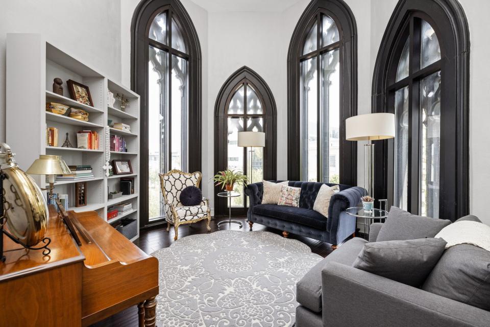 A condo at Meridian Arch, in the converted former Meridian Street Methodist Episcopal Church, 802 N. Meridian St., features include soaring curved ceilings, arched moldings and distinctive quatrefoil tracery windows.