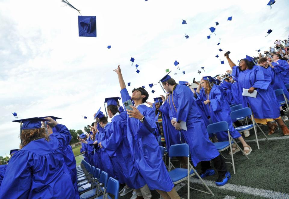 Graduates toss their caps during the Blue Hills Regional Technical High School graduation in Canton, Tuesday, June 7, 2022.