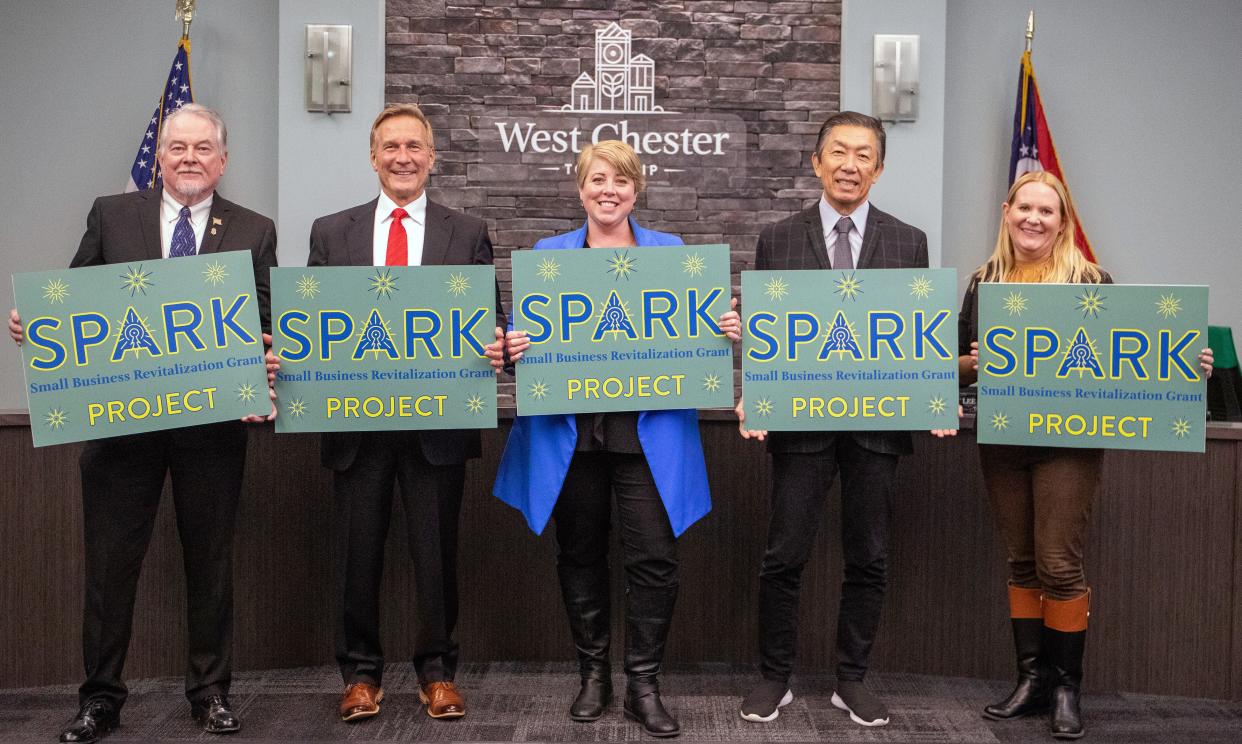 West Chester Township officials, from left, Bruce Jones, Mark Welch, Ann Becker, Lee Wong, and Katy Kanelopoulos with signs for the township's new Spark grant program for small businesses.