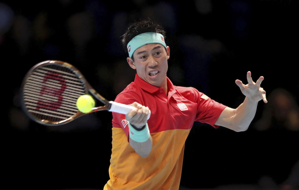 Japan's Kei Nishikori returns a shot to Austria's Dominic Thiem, during the ATP World Tour Finals men's singles tennis match at the O2 arena in London, Thursday, Nov. 15, 2018. (John Walton/PA via AP)