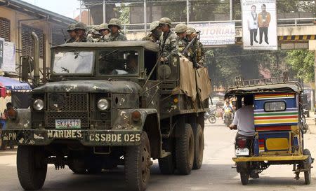 Soldiers ride in a truck as they patrol a road in Jolo, Sulu, in southern Philippines September 25, 2014. REUTERS/Stringer