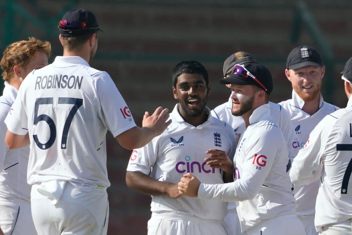 Rehan Ahmed, centre, celebrates a wicket with his England team-mates (Fareed Khan/PA) (AP)