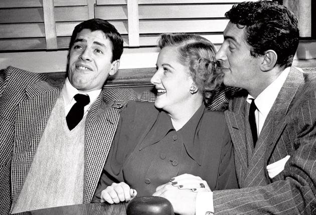 Lewis goes through his comic routine for an appreciative Margaret Whiting and Dean Martin in 1949 (AP)