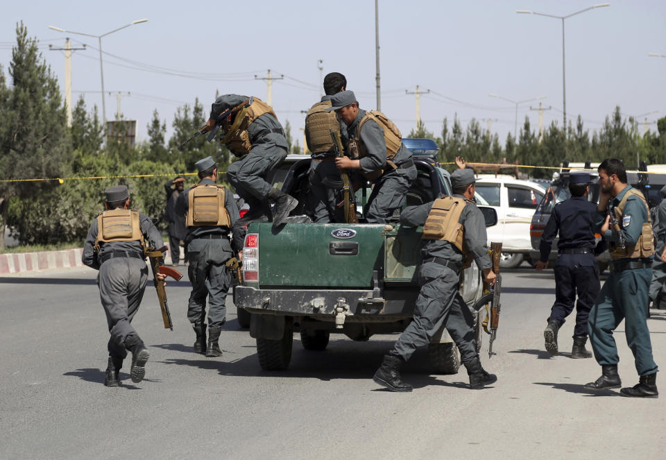 FILE - In this May 30, 2018, file photo, Afghan Security personnel arrive at the site of deadly attack on the interior ministry, in Kabul, Afghanistan. As the Trump administration pushes for peace in Afghanistan, a new U.S. watchdog report says Afghan security forces are shrinking, gaps in security are growing, and the Taliban are largely holding their own despite a surge in American bombing. (AP Photo/Rahmat Gul, File)