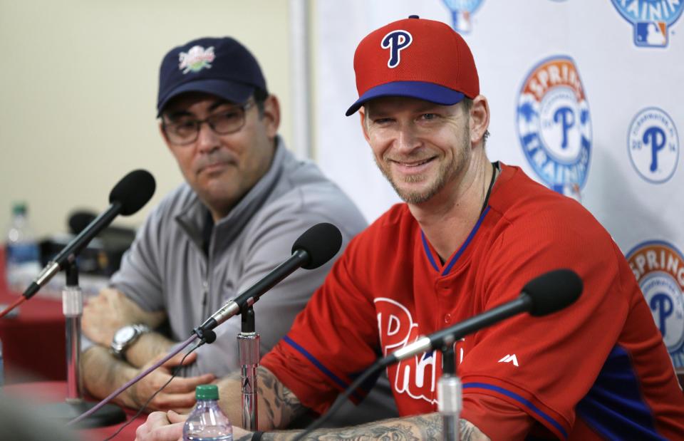 Philadelphia Phillies pitcher A.J. Burnett, right, speaks during a news conference as Phillies general manager Ruben Amaro Jr., left, looks on following a spring training baseball practice on Sunday, Feb. 16, 2014, in Clearwater, Fla. (AP Photo/Charlie Neibergall)