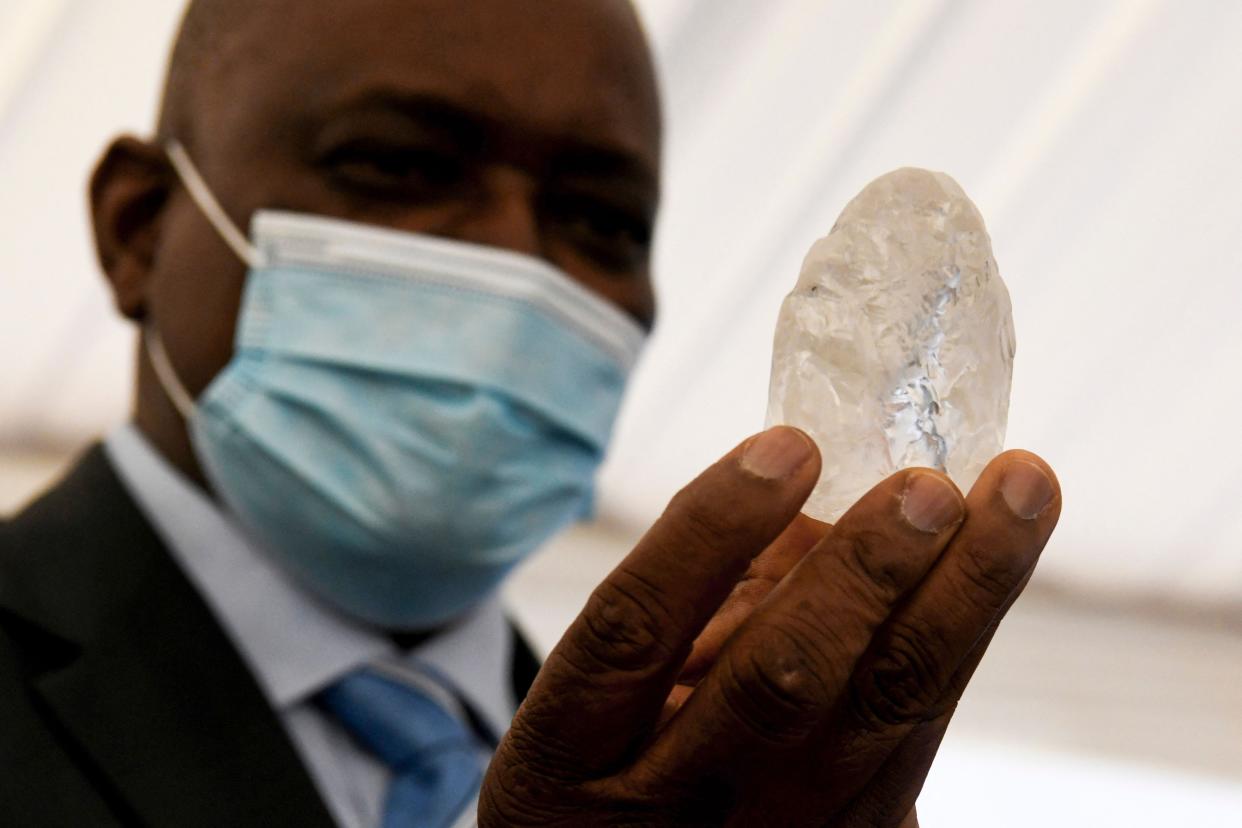 Botswana President Mokgweetsi Masisi holds a gem diamond in Gaborone, Botswana, on Wednesday. 