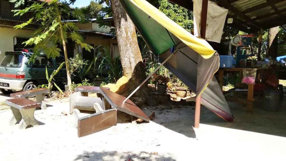 The powerful gusts caused damage to a few homes on the island. — Picture via Facebook/Cik Puan Noor