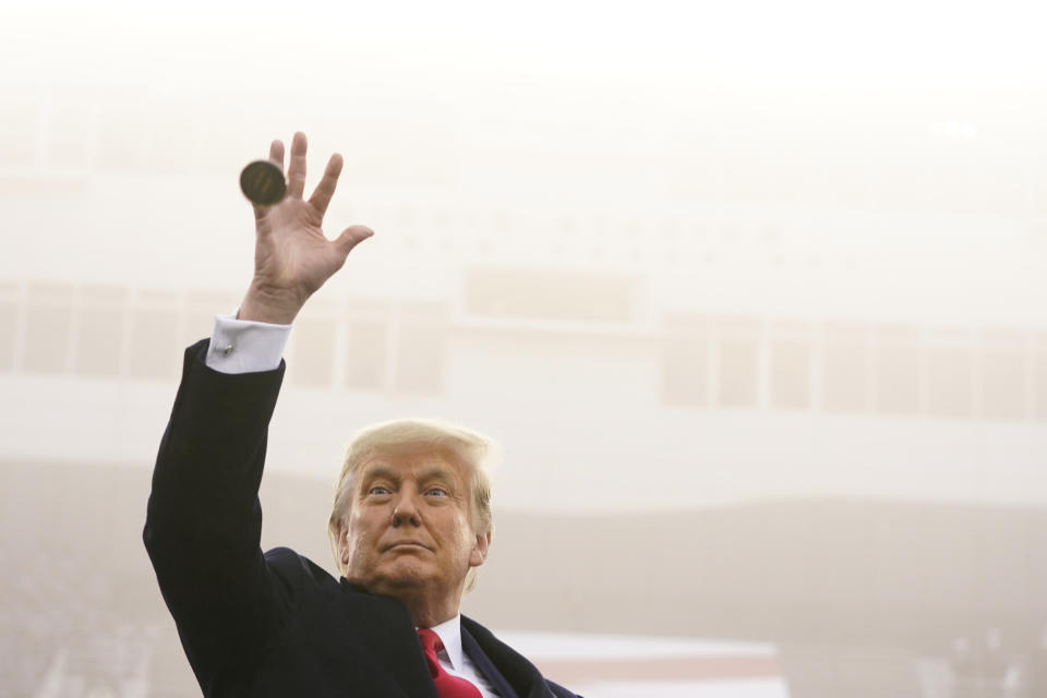 President Donald Trump throws the coin in the air before the start of the 121st Army-Navy Football Game in Michie Stadium at the United States Military Academy, Saturday, Dec. 12, 2020, in West Point, N.Y. (AP Photo/Andrew Harnik)