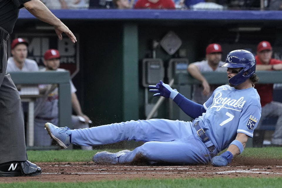 Kansas City Royals' Bobby Witt Jr. slides home to score on a double by Salvador Perez during the first inning of a baseball game against the St. Louis Cardinals Friday, Aug. 11, 2023, in Kansas City, Mo. (AP Photo/Charlie Riedel)