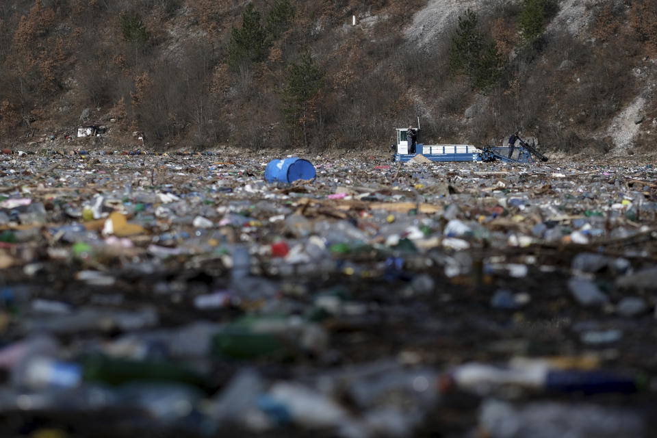 A machine collects garbage from the Drina river near Visegrad, eastern Bosnia, Wednesday, Feb. 24, 2021. Environmental activists in Bosnia are warning that tons of garbage floating down the Balkan country's rivers are endangering the local ecosystem and people's health. The Drina River has been covered for weeks with trash that has piled up faster than the authorities can clear it out. (AP Photo/Kemal Softic)