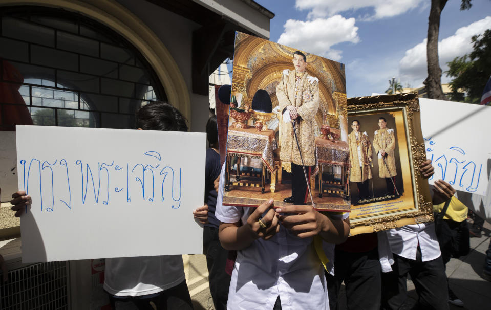 Supporters of Thailand's monarchy hold posters that read "long live the King" and portraits of Thailand's King Maha Vajiralongkorn and portraits of the late King Bhumibol Adulyadej as they gatherto show their concern over the country's pro-democracy movement, which they feel besmirches the royal institution in Bangkok, Thailand, Thursday, July 30, 2020. The demonstration was held at Democracy Monument, a traditional venue for protests of all political stripes that in recent weeks has hosted several larger pro-democracy, anti-government protests organized by students. (AP Photo/Sakchai Lalit)