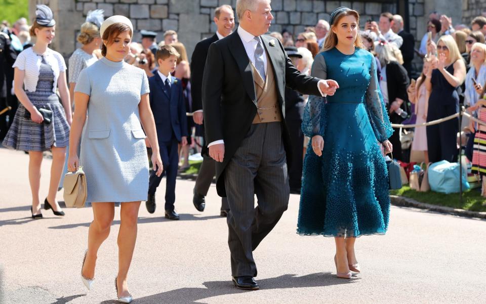 rincess Eugenie of York (L), Britain's Prince Andrew, Duke of York, (C) and Britain's Princess Beatrice of York (R) arrive for the wedding ceremony of Britain's Prince Harry, Duke of Sussex and US actress Meghan Markle - AFP 