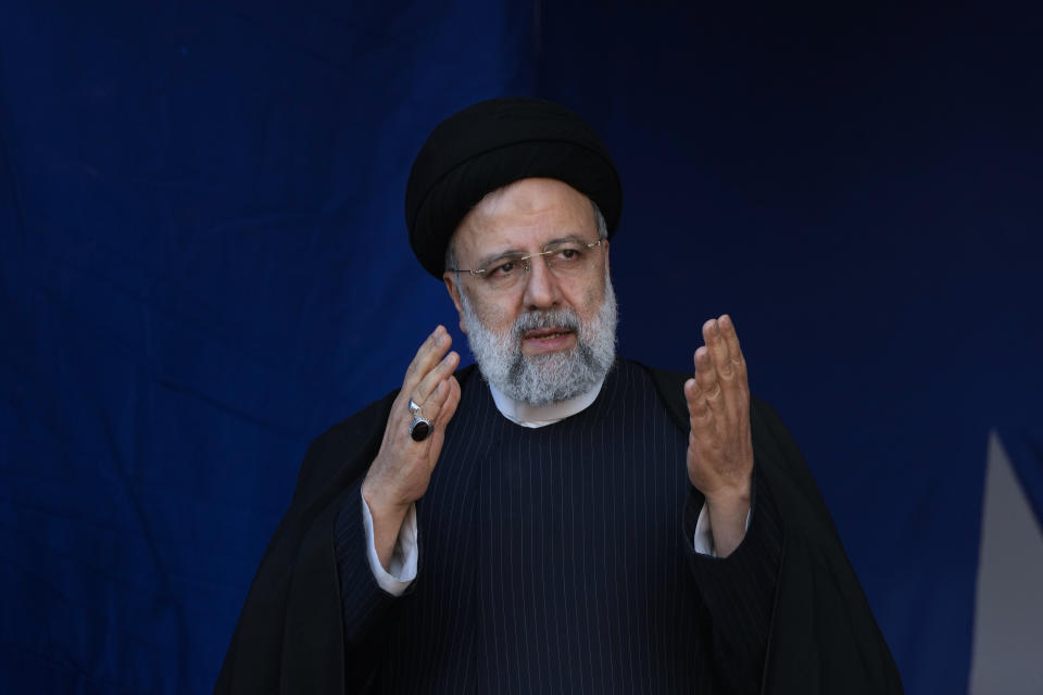 Iranian President Ebrahim Raisi waves to the crowd during the funeral ceremony of the victims of Wednesday's bomb explosion in the city of Kerman about 510 miles (820 kms) southeast of the capital Tehran, Iran, Friday, Jan. 5, 2024. Iran on Friday mourned those slain in an Islamic State group-claimed suicide bombing targeting a commemoration for a general slain in a U.S. drone strike in 2020, as the death toll in the attack rose to at least 89. (AP Photo/Vahid Salemi)