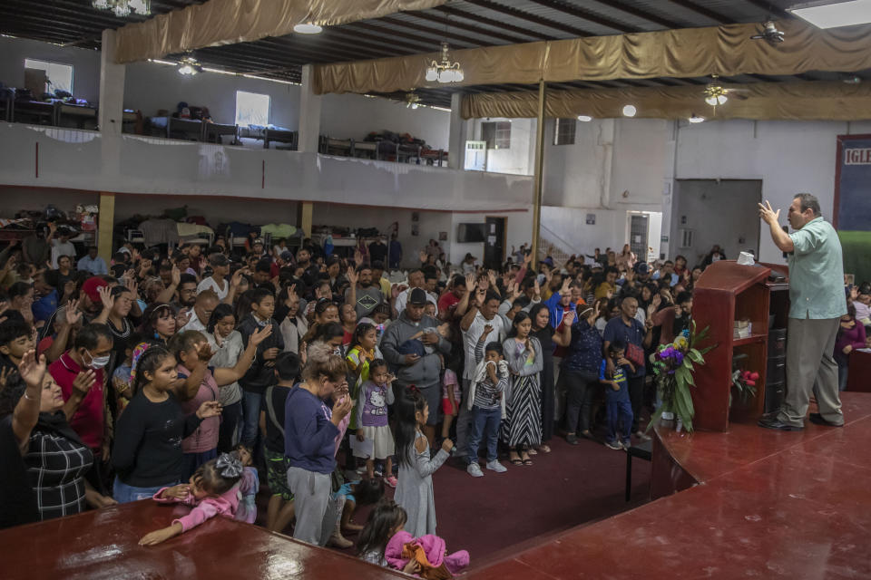 Mexican migrants, many from Michoacan state, attend a religious service at the "Embajadores de Jesus" Christian migrant shelter in Tijuana, Mexico, Tuesday, Sept. 26, 2023. While many places in Mexico provide shelter for migrants from other countries, some shelters in Tijuana have seen an influx of Mexicans fleeing violence, extortion and threats by organized crime. (AP Photo/Karen Castaneda)