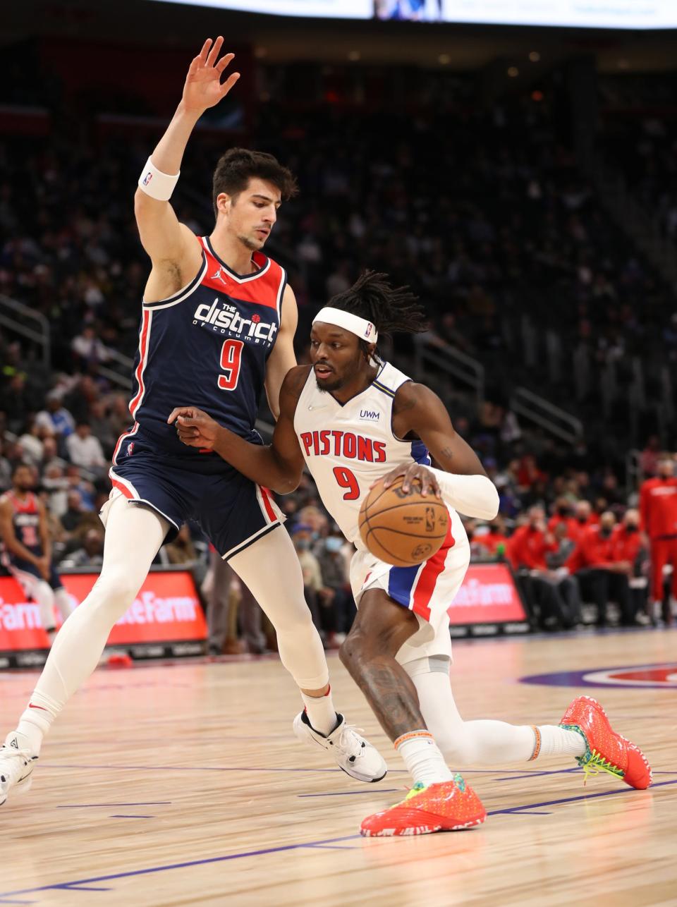 Pistons forward Jerami Grant drives against Wizards forward Deni Avdija on Dec. 8, 2021, at Little Caesars Arena.