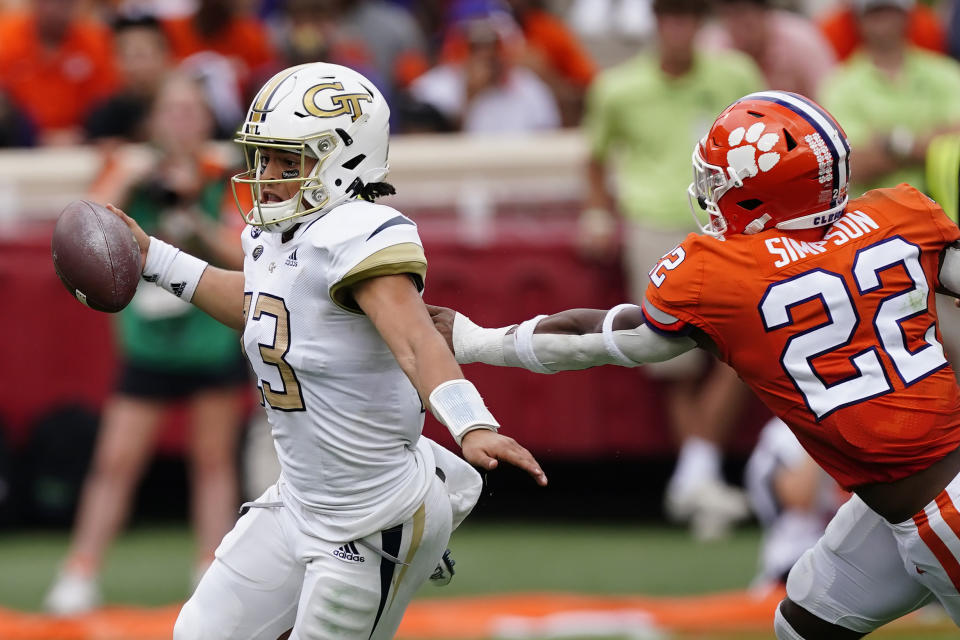 Georgia Tech quarterback Jordan Yates (13) tries to escape from Clemson linebacker Trenton Simpson (22) in the first half of an NCAA college football game Saturday, Sept. 18, 2021, in Clemson, S.C. (AP Photo/John Bazemore)