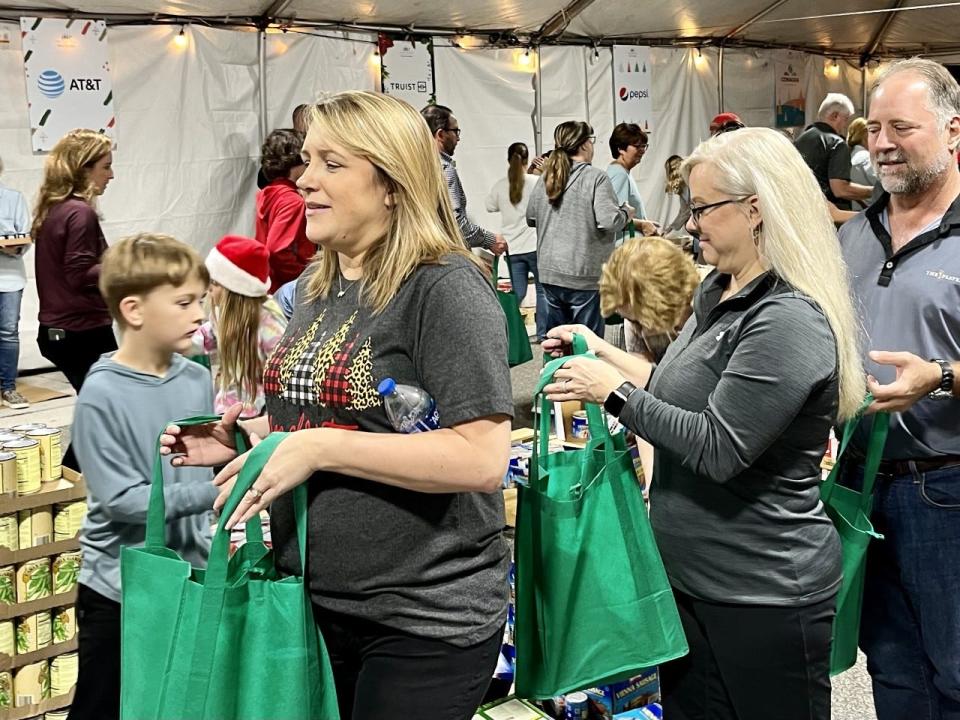 Volunteers load bags of food for the needy during the 11th annual Furyk Foundation Hope for the Holidays campaign at the TPC Sawgrass.