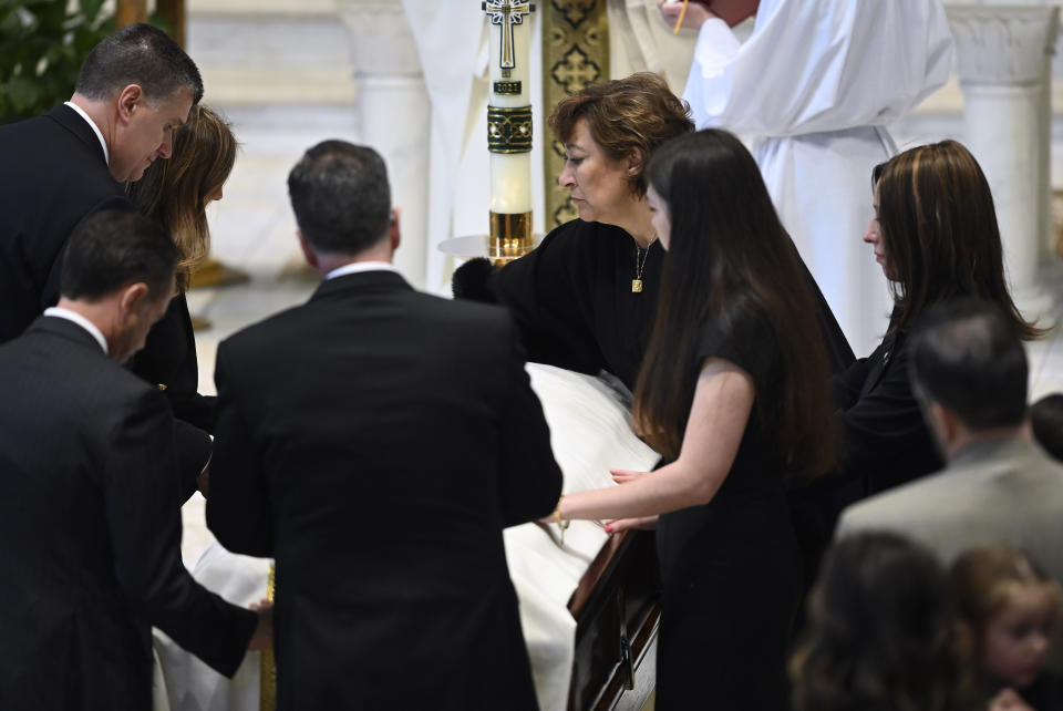 Family members, including mother, Mary 'Mia' Fraser, center-right, place the pall on the casket of Brian Fraser as family members, friends and supporters gather during the funeral mass for Brian Fraser at St Paul on the Lake Catholic Church, in Grosse Pointe Farms, Mich., Saturday, Feb. 18, 2023. Fraser was identified as one of three students slain during a mass shooting on Michigan State University's campus, Monday evening. (Todd McInturf/Detroit News via AP, Pool)