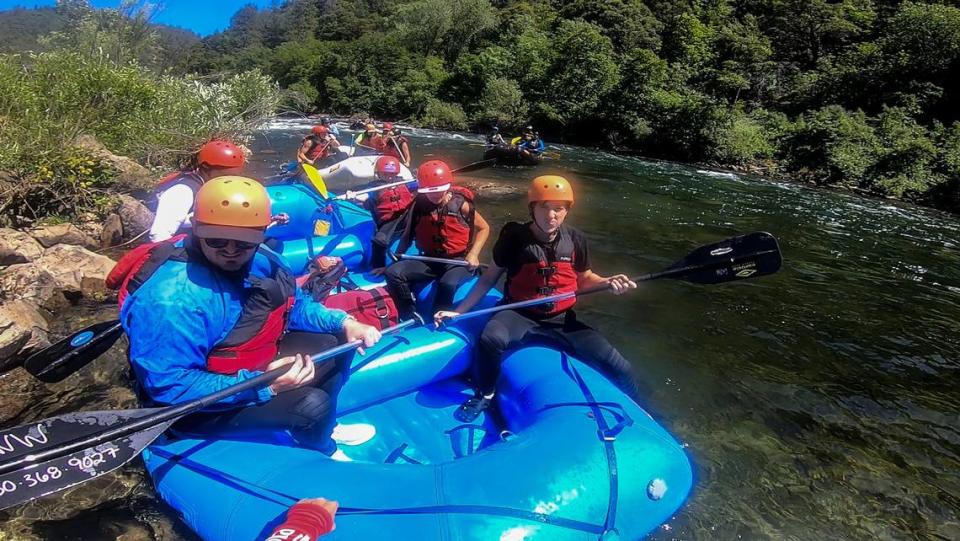 Sacramento Bee reporter Chris Biderman, left, prepares to disembark a raft at the end of a tour on the Middle Fork of the American River in May.