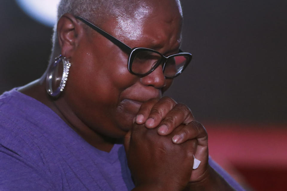 Delicia Harris, 50, a survivor of domestic violence, prays at the SOAR Assembly, Thursday, July 22, 2021, in Rockford, Ill. The eruption in violence in the city among people stuck at home wasn't a surprise to Harris who has worked with youth programs in Rockford. The money flowing to cities and states from the American Rescue Plan is so substantial and can be used for so many purposes that communities across the U.S. are trying out new, longer-term ways to fix what’s broken in their cities. (AP Photo/Shafkat Anowar)