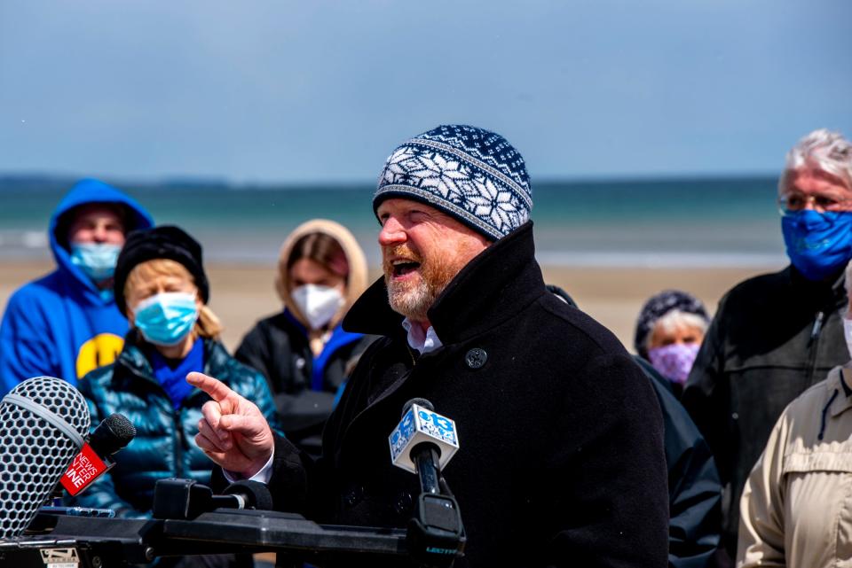 Benjamin E. Ford, a partner in the new Portland-based law firm Archipelago Law, holds a press conference Thursday, April 22, 2021, at the border of Moody Beach in Wells and North Beach in Ogunquit, after filing a lawsuit that he said aims to reclaim the intertidal zone of Maine beaches for public access.