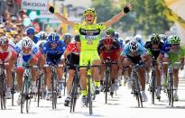 FILE PHOTO: Italy's Andrea Guardini celebrates after crossing the finish line to win the 149-km, 18th stage of the Giro d'Italia.