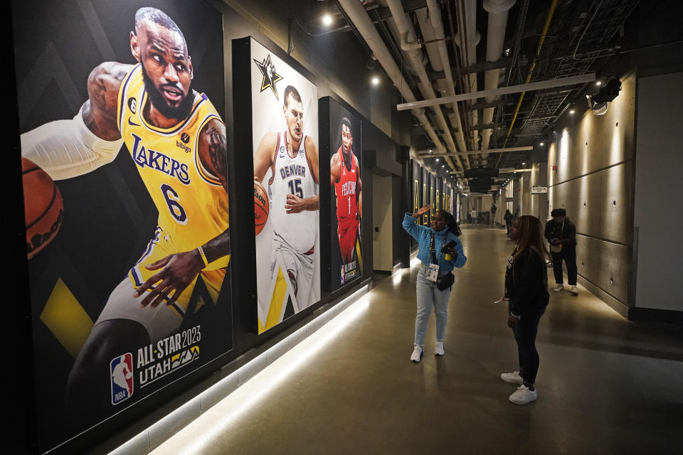 Photographs of Los Angeles Lakers' LeBron James, left, Denver Nuggets' Nikola Jokic, center, and New Orleans Pelicans' Zion Williamson are shown in the Vivint Arena during the transformation taking place inside the arena before the start of the NBA basketball All-Star weekend Wednesday, Feb. 15, 2023, in Salt Lake City. More than 60 players are making their way to Salt Lake City for All-Star weekend, some of them for the first time, one of them for the 19th time. And while some events will tout the league's future, many will be celebrating the past.(AP Photo/Rick Bowmer)