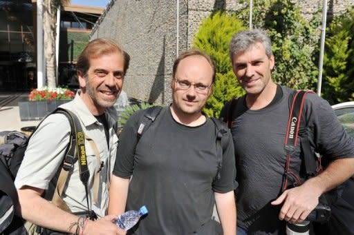 From left: AFP photographer Roberto Schmidt, journalist Dave Clark and Getty Images photographer Joe Raedle in Tripoli, hours after being released by their captors. Clark tells of the uncertainty surrounding his four-day detention, along with his photographer colleagues, where he was kept at the mercy Libyan leader Moamer Kadhafi's powerful and unpredictable regime