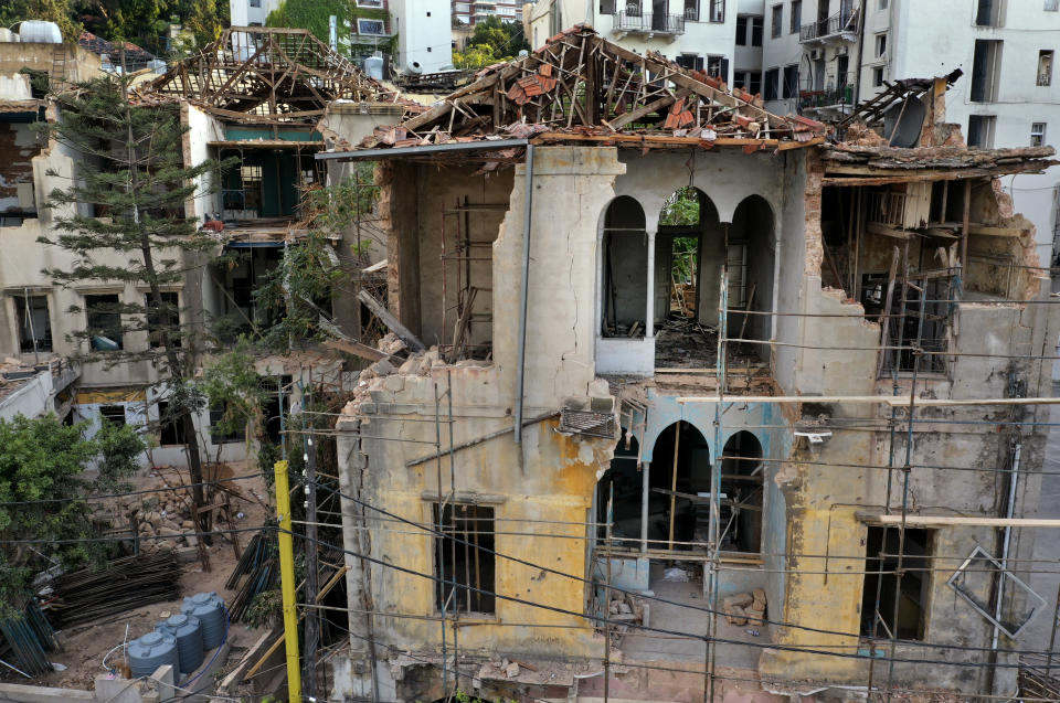 A heritage house that was destroyed by Aug. 4 explosion that hit the seaport of Beirut, is seen hold by scaffolding, in Beirut, Lebanon, Thursday Aug. 27, 2020. In the streets of Beirut historic neighborhoods, workers are erecting scaffolding to support buildings that have stood for more than a century - now at risk of collapse after the massive Aug. 4 explosion that tore through the capital. (AP Photo/Hussein Malla)