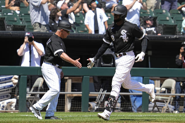Chicago White Sox's Luis Robert Jr., right, celebrates with third base coach Eddie Rodriguez after hitting a solo home run during the fourth inning of a baseball game against the Kansas City Royals in Chicago, Sunday, May 21, 2023. (AP Photo/Nam Y. Huh)