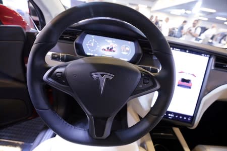 FILE PHOTO: The logo of Tesla carmaker is seen inside a car at the Top Marques fair in Monaco