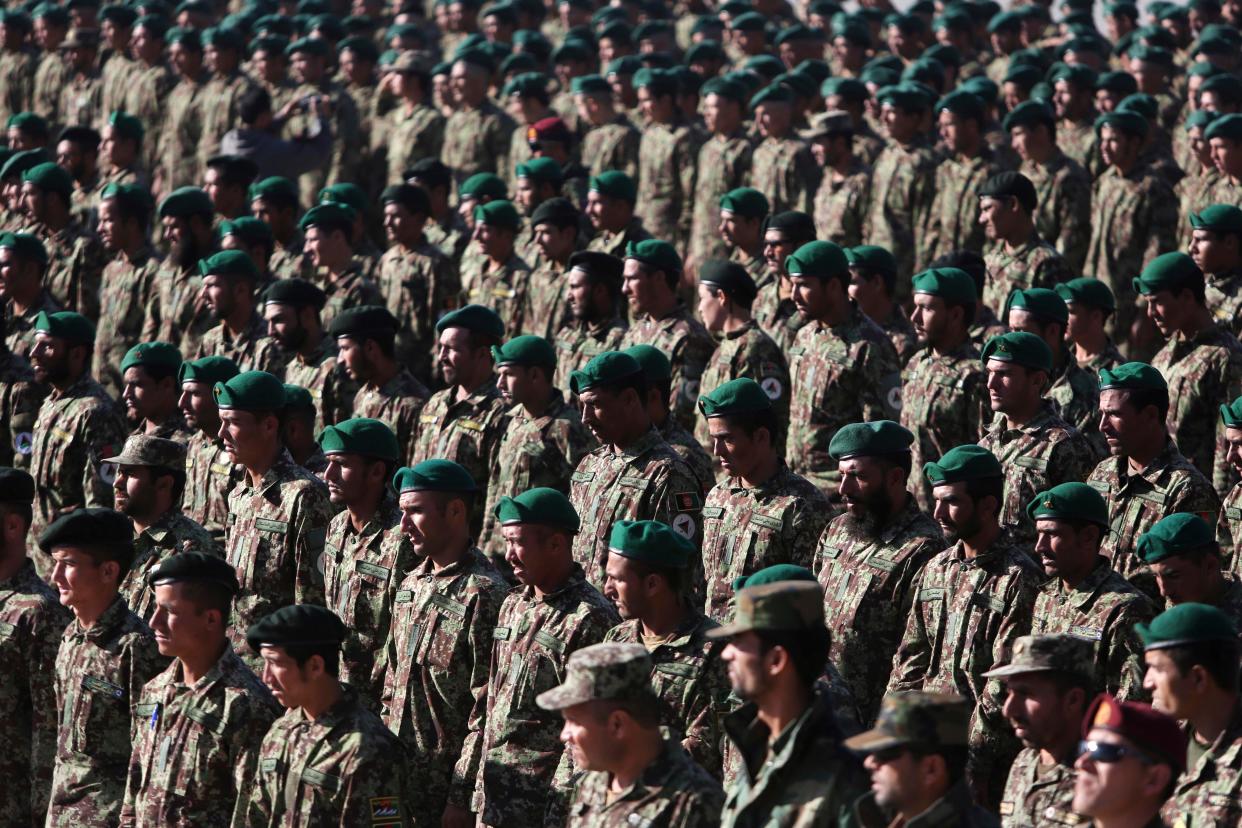 New members of the Afghan National Army attend their graduation ceremony at the Afghan Military Academy in Kabul, Afghanistan on Sunday, Nov. 23, 2014. (AP Photo/Rahmat Gul)