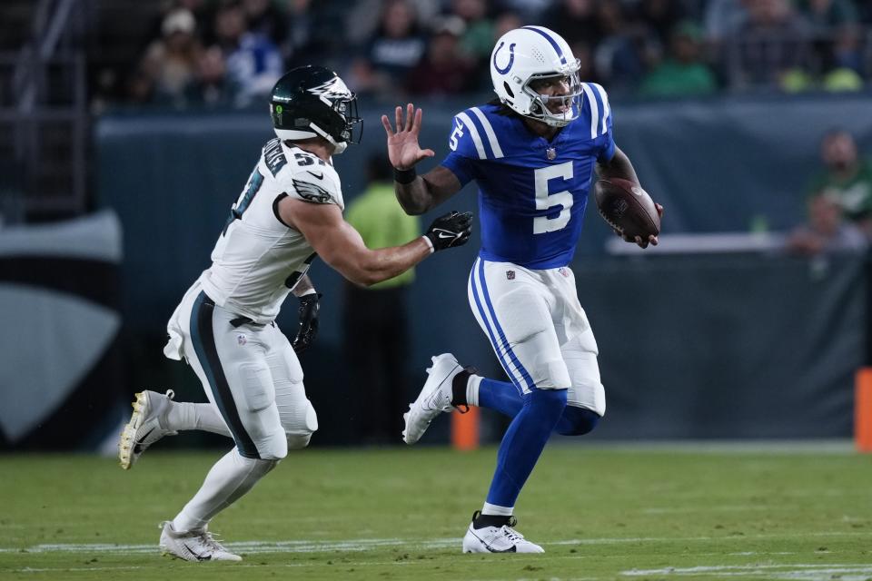 Indianapolis Colts quarterback Anthony Richardson (5) runs with the ball under pressure from Philadelphia Eagles linebacker Ben VanSumeren (57) during the first half of an NFL preseason football game Thursday, Aug. 24, 2023, in Philadelphia. (AP Photo/Matt Slocum)