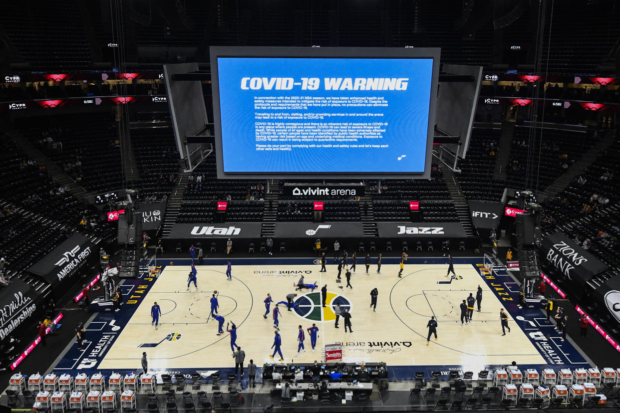 A COVID-19 warning is displayed over the floor before a game between the Utah Jazz and New York Knicks at Vivint Smart Home Arena earlier this season. (Alex Goodlett/Getty Images)