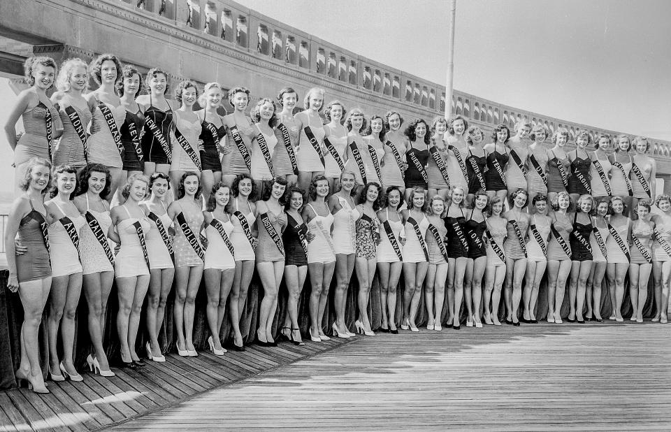 FILE - Contenders for the title of Miss America line up on the Boardwalk at Atlantic City, N.J., on Sept. 2, 1952. In the late 1930s, 40s and 50s, minority women were excluded from competition by "rule number seven," which stated that contestants had to be "of good health and of the white race." Having managed to maintain a complicated spot in American culture, the competition is marking its 100th anniversary, on Thursday, Dec. 16, 2021. (AP Photo/File)