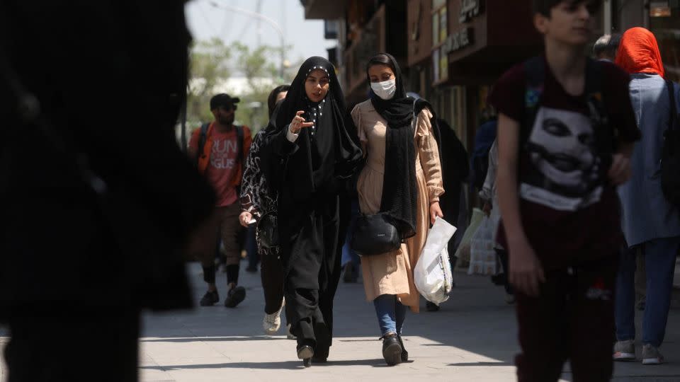 Women walk on the street in Tehran on April 15, 2023. On Thursday, the Iranian parliament passed a controversial bill ramping up penalties against women who do not wear the hijab properly. - Majid Asgaripour/WANA/Reuters