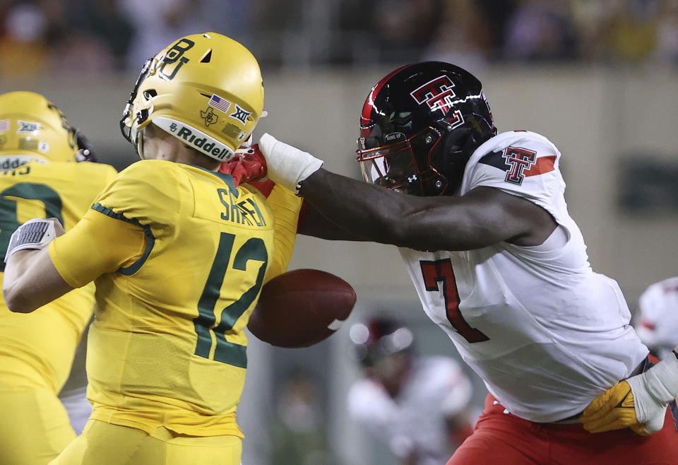 Texas Tech linebacker Steve Linton (7) knocks the ball loose from Baylor quarterback Blake Shapen (12) for a Texas Tech fumble recovery in the first half of an NCAA college football game, Saturday, Oct. 7, 2023, in Waco, Texas. (Jerry Larson/Waco Tribune-Herald, via AP)