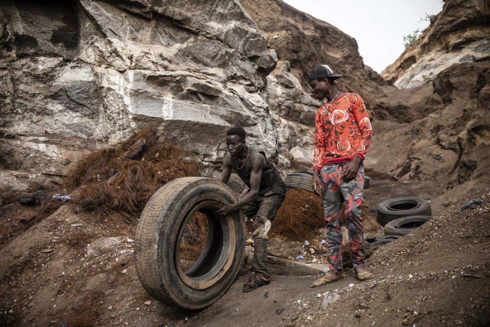 Men work in a Pissy granite mine in Ouagadougou, Burkina Faso, Monday April 25, 2022. he influx of people displaced by the country's rapidly rising Islamic violence is causing competition among the approximately 3,000 people working at the granite mine. At least 500 displaced people started working at the mine last year making it harder for the original miners to earn a living, said Abiba Tiemtore, head of the site. (AP Photo/Sophie Garcia)