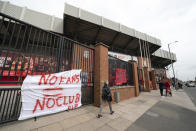 Banners are seen outside Liverpool's Anfield Stadium after the collapse of English involvement in the proposed European Super League, Liverpool, England, Wednesday, April 21, 2021. Liverpool owner John W Henry has apologised to the club's supporters for the "disruption" caused by the proposed European Super League (ESL). (AP Photo/Jon Super)