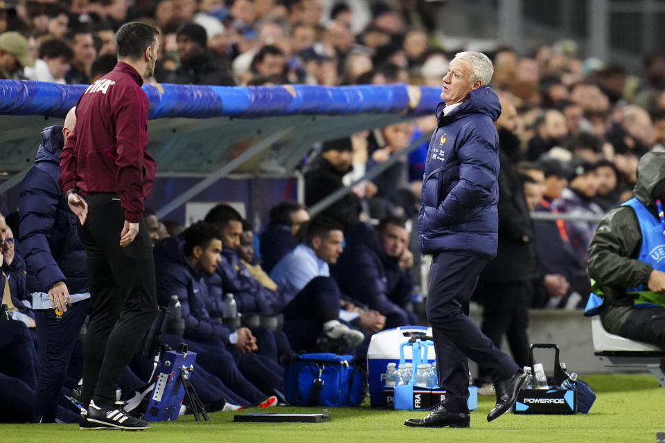 France's coach Didier Deschamps, right, talks to a referee during an international friendly soccer match between France and Chile at the Orange Velodrome stadium in Marseille, southern France, Tuesday, March 26, 2024. (AP Photo/Daniel Cole)