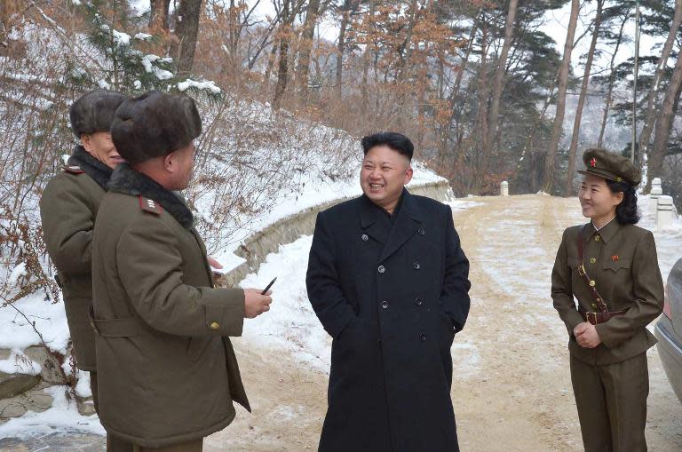 Undated KCNA handout photo provided on January 23, 2014 shows North Korean leader Kim Jong-Un (C) visiting the revolutionary battle site at Mount Madu in South Pyongan province