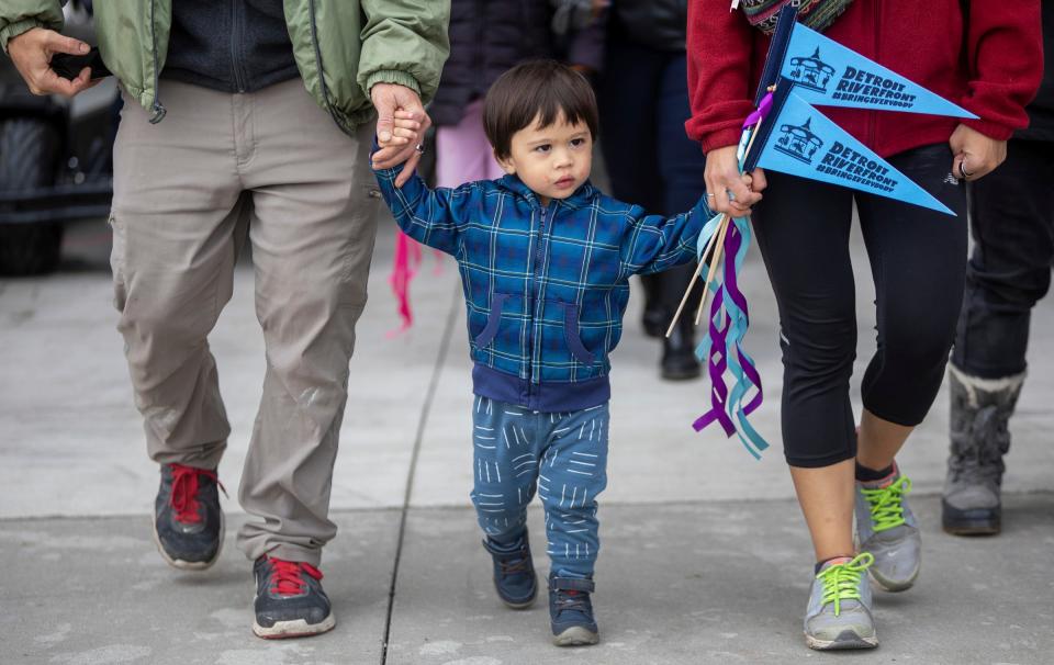 Families take to the trail during the Uniroyal Promenade ribbon-cutting ceremony on Detroit's Riverwalk in Detroit on Saturday, Oct. 21, 2023. The new Uniroyal Promenade completes the 3.5 mile-long Riverwalk and provides access to Belle Isle.