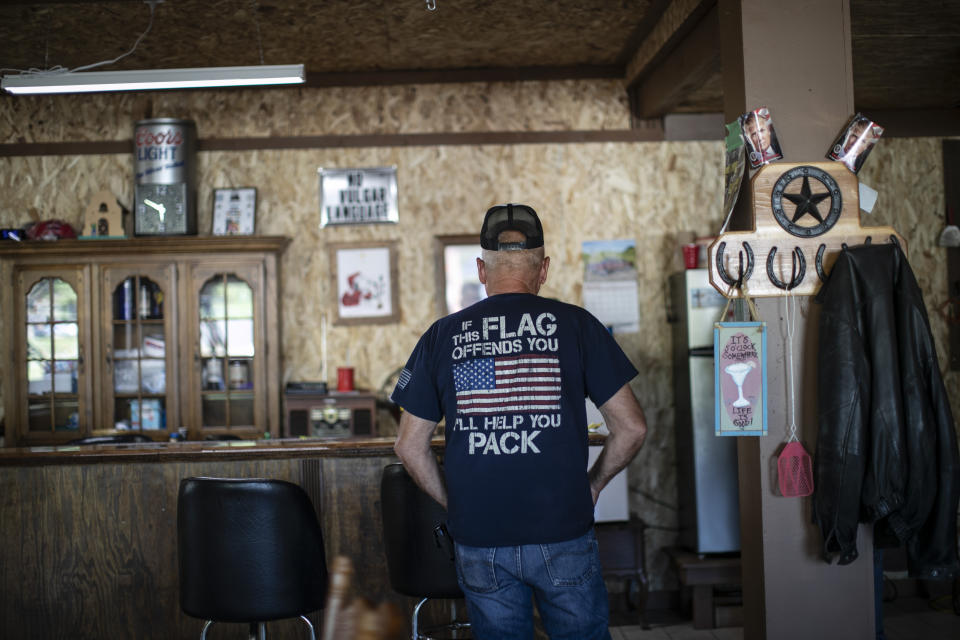 Bill Stevens, 76, stands in The Gunsmoke Club Tuesday, Aug. 4, 2020, in West Vienna, Ill. This is a deeply conservative part of the nation _ 77 percent of the county voted for President Donald Trump in the 2016 elections; just 19 percent went for Hillary Clinton. (AP Photo/Wong Maye-E)