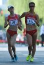 China's Lu Xiuzhi (R) and China's Liu Hong compete in the women's 20 kilometres race walk final at the IAAF World Championships at Beijing's Bird's Nest stadium on August 28, 2015