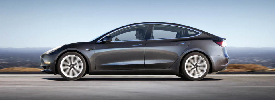 A Tesla Model 3 viewed from the side.