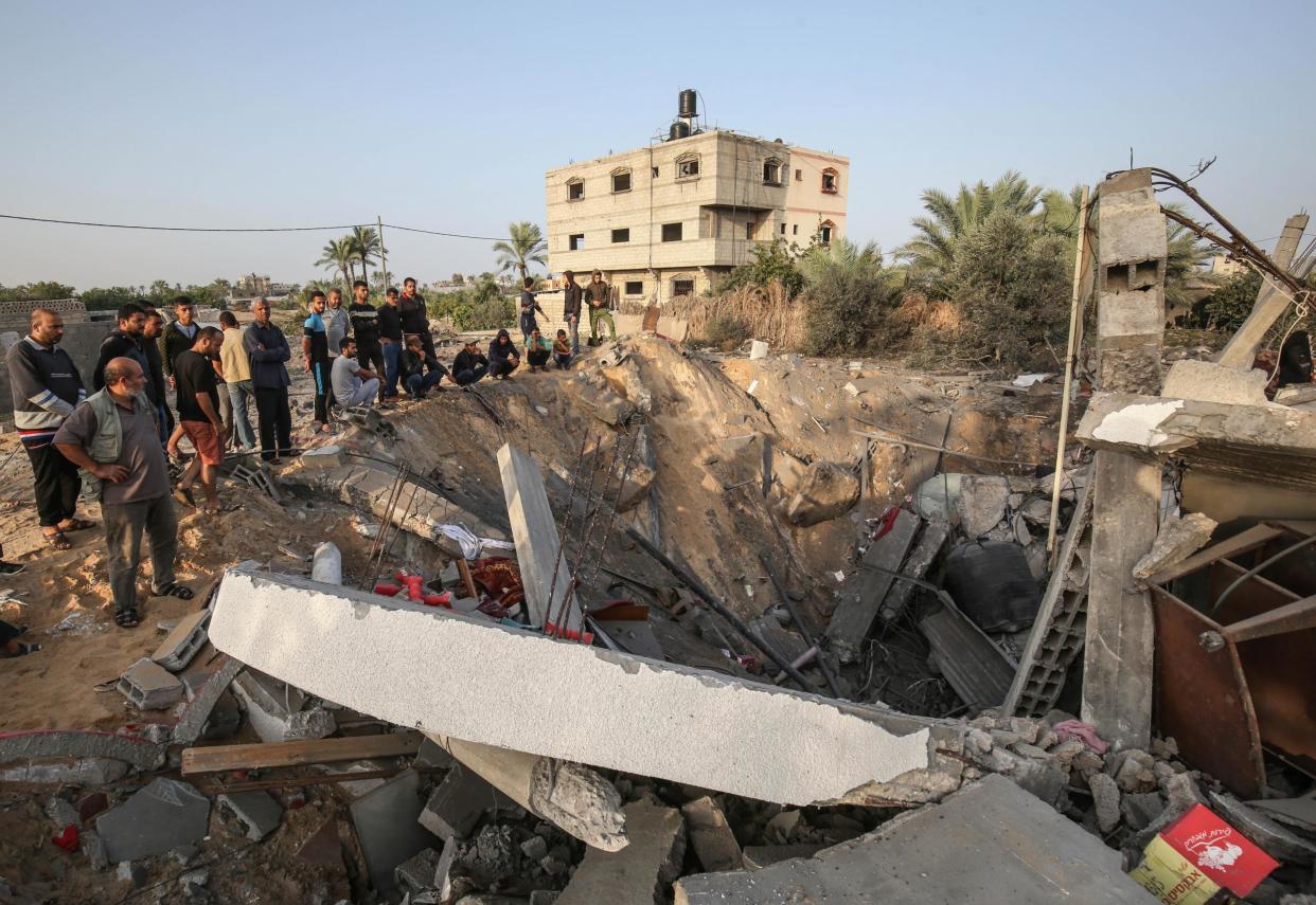 Palestinians check the remains of a house destroyed in an Israeli airstrike at Khan Yunis, in the southern Gaza Strip, on 13 November 2019: AFP/Getty