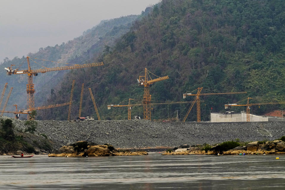 Fisherman catch fish in Mekong river in front of construction site of Luang Prabang dam in Luang Prabang, Laos, Sunday, Jan. 28, 2024. Luang Prabang was named a UNESCO World Heritage Site nearly 30 years ago, but a multibillion-dollar dam project is raising questions that could deprive the city of its coveted status and prompting broader concerns the Mekong River could be ruined by multiple dams that are being planned. (AP Photo/Sakchai Lalit)