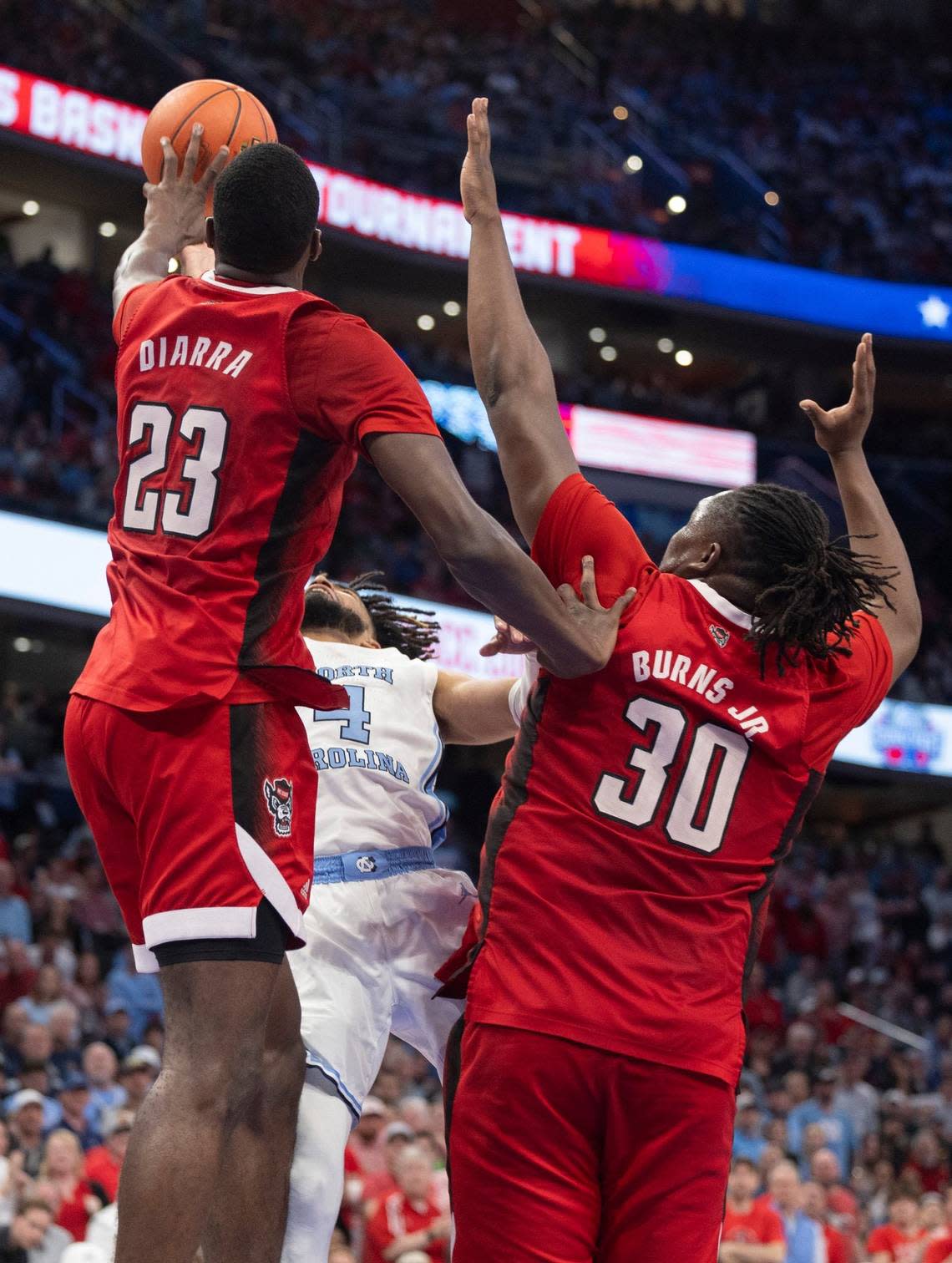 North Carolina’s D.J. Burns Jr. (30) and Mohamed Diarra (23) smother North Carolina’s R.J. Davis (4) with defense in the second half during the ACC Men’s Basketball Tournament Championship at Capitol One Arena on Saturday, March 16, 2024 in Washington, D.C.