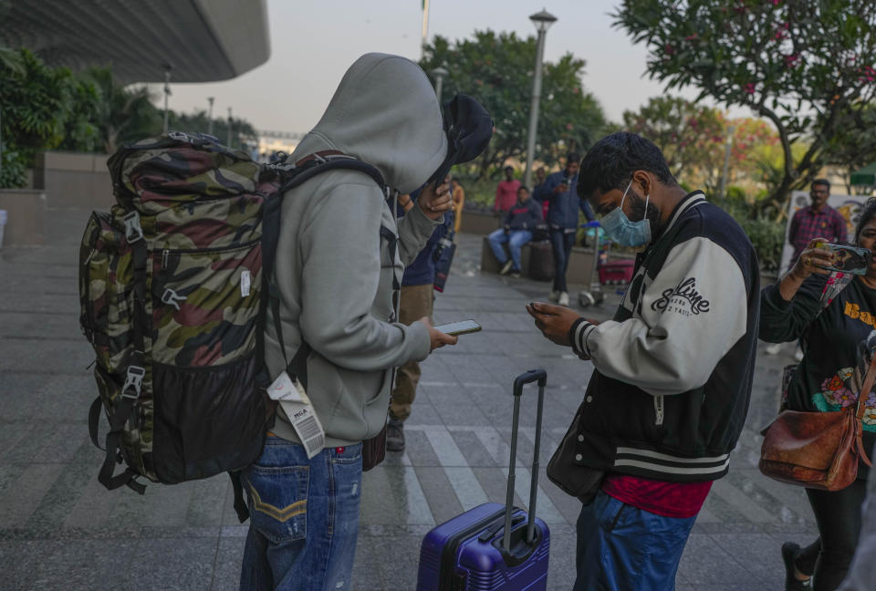 Indian passengers who travelled in an unmarked Legend Airlines A340 from Vatry Airport in France, arrive at the Chhatrapati Shivaji Maharaj International Airport in Mumbai, India, Tuesday, Dec. 26, 2023. A charter plane that was grounded in France for a human trafficking investigation arrived in India with 276 Indians aboard early Tuesday, authorities said. The passengers had been heading to Nicaragua but were instead blocked inside the Vatry Airport for four days in an exceptional holiday ordeal. (AP Photo/Rafiq Maqbool)