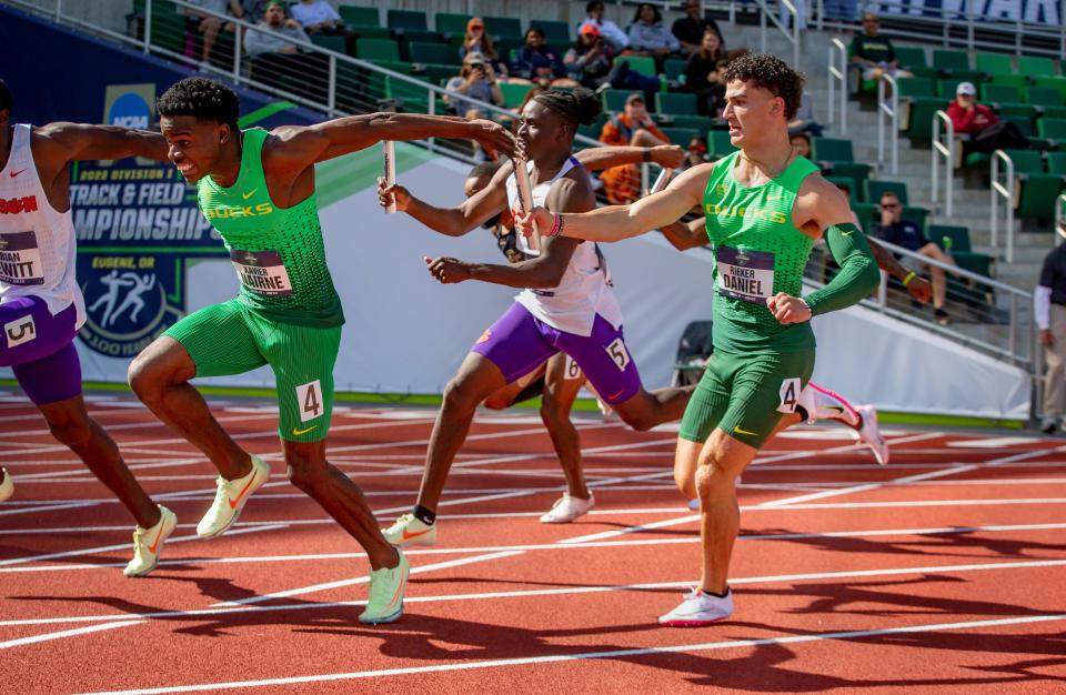 Oregon’s Daniel Rieker hands the baton to teammate Xavier Nairne on the final handoff of the semifinals of the men’s 4x100 meter relay at the NCAA Outdoor Track & Field Championships at Hayward Field Wednesday, June 8, 2022, in Eugene, Ore. 